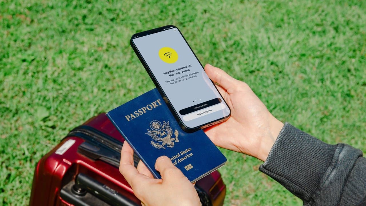 Person holding a passport and a smartphone