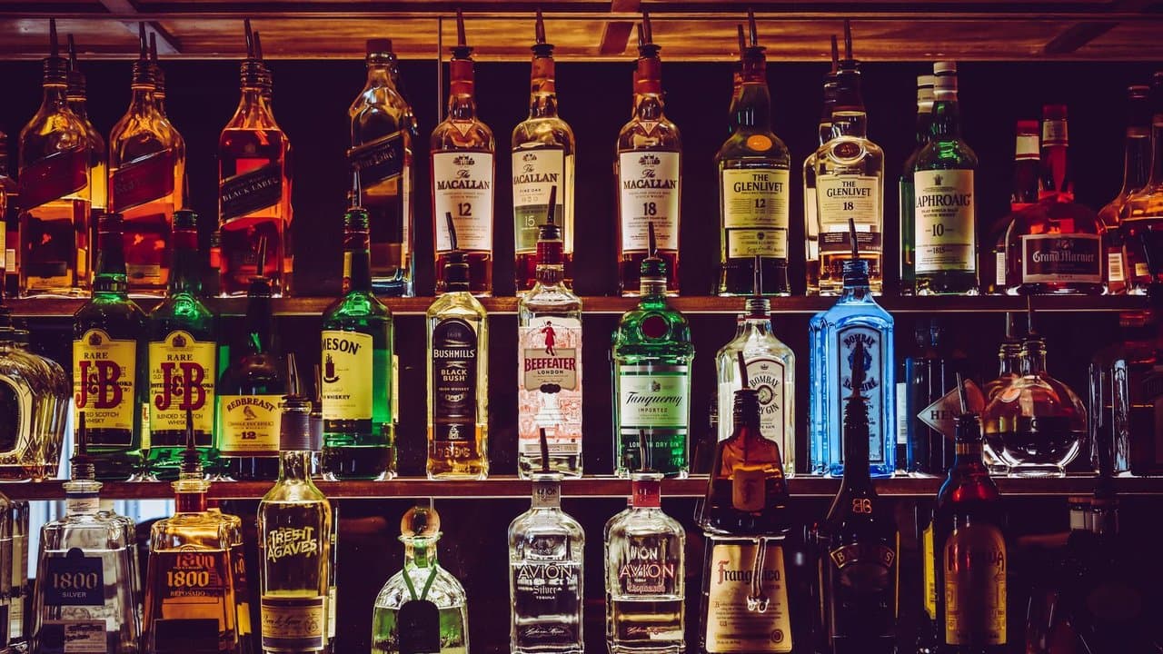 Shelf of liquor bottles in a professional bar setting