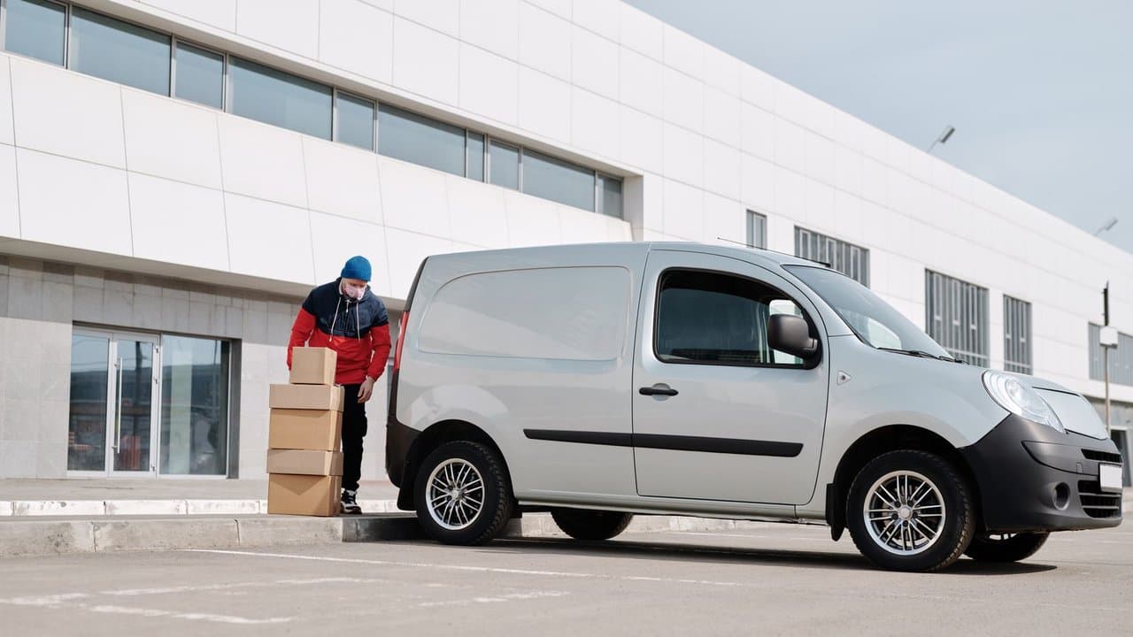 Delivery driver with packages at a residential building