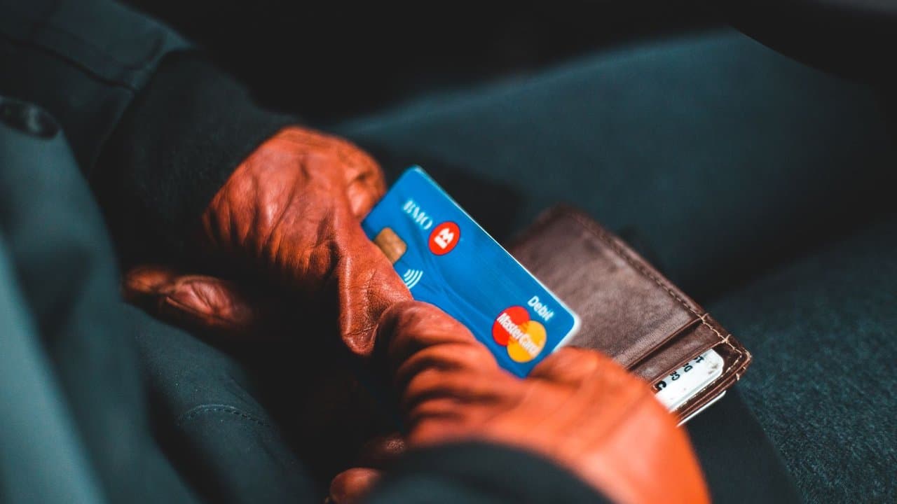 Hands holding a credit card for digital payment