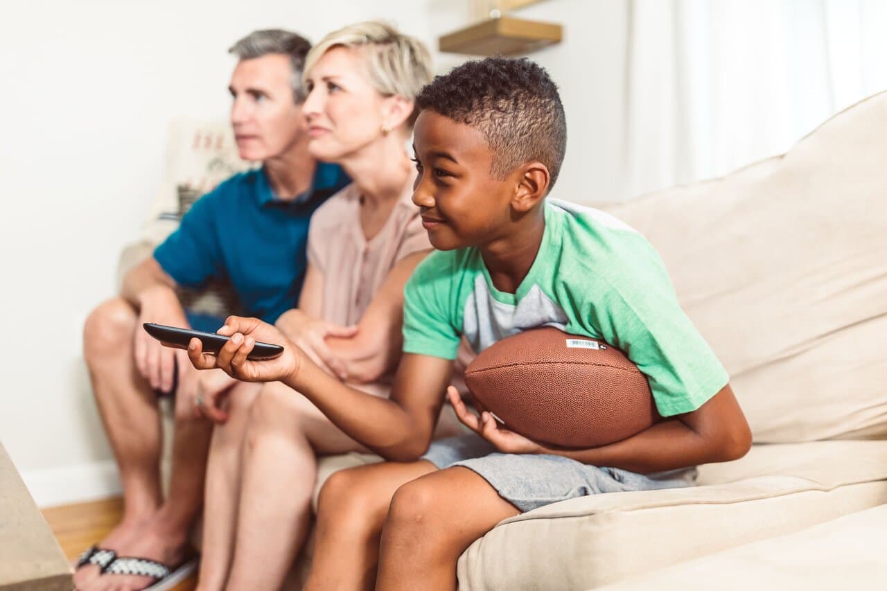 Family watching television together in the living room