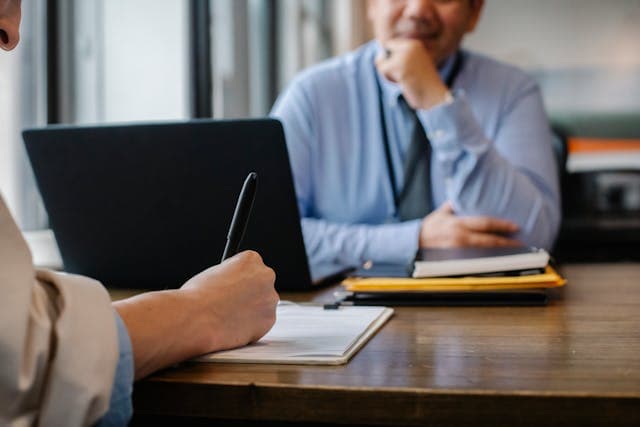 Business professional reviewing compliance documentation in a formal setting